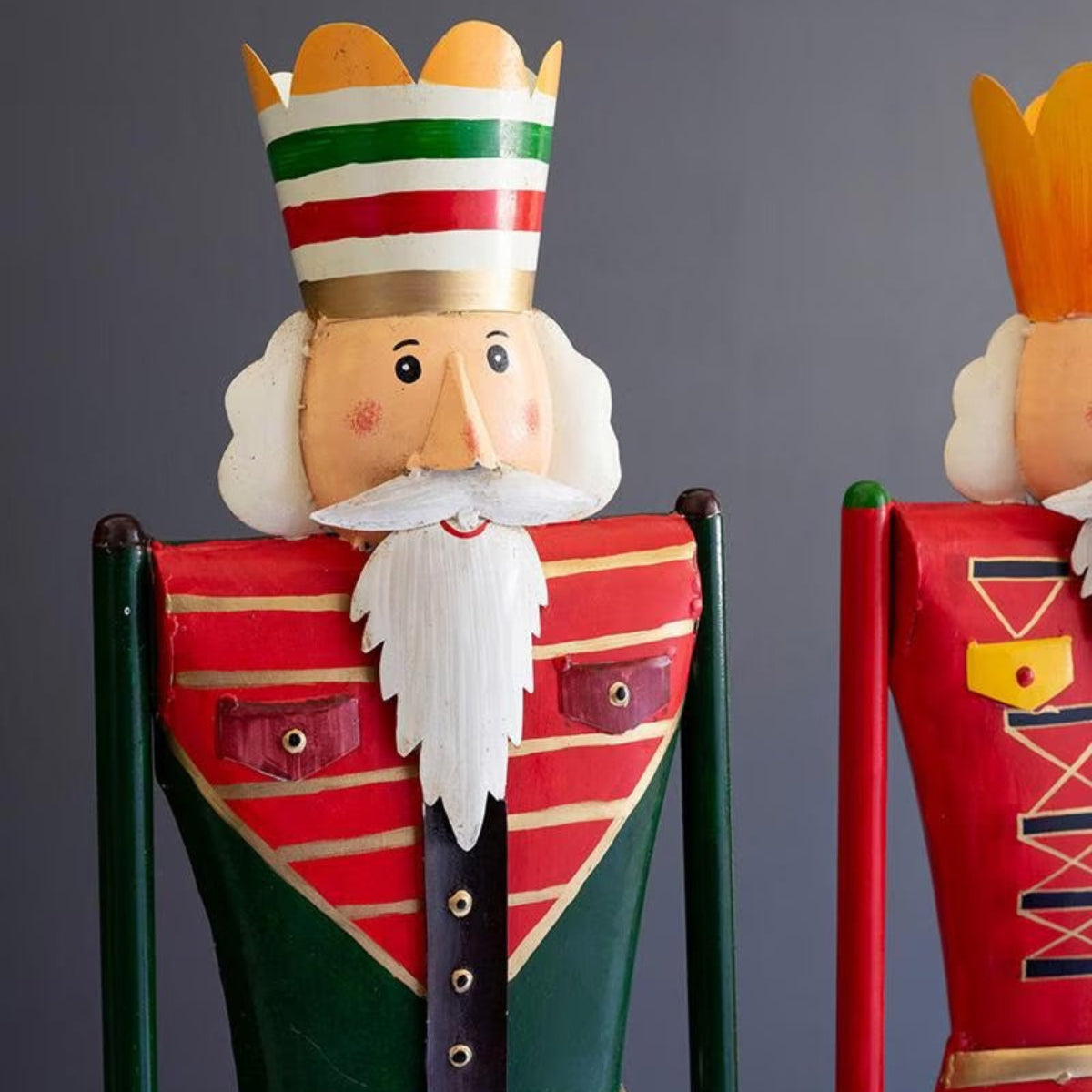 Timberline Nutcracker Guards, set of 2 hand-painted red and green metal nutcrackers on tall wood posts