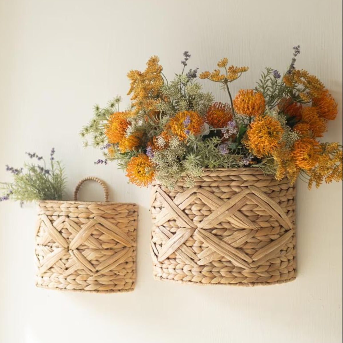 Woven wall baskets styled with dried florals on a light wall