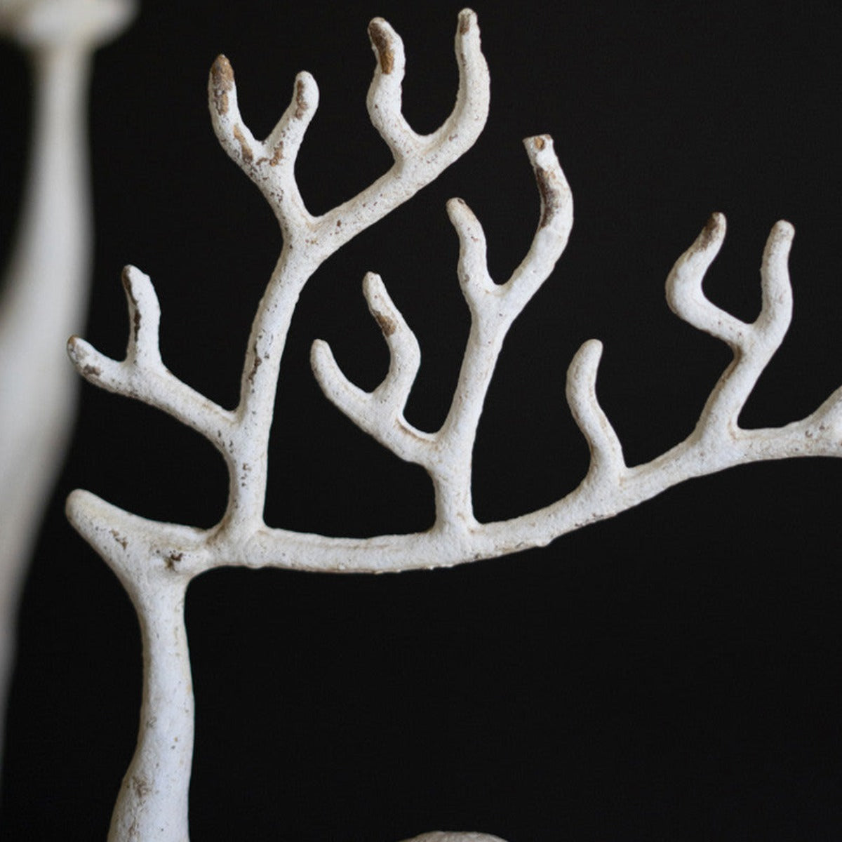 Two distressed white cast iron deer statues