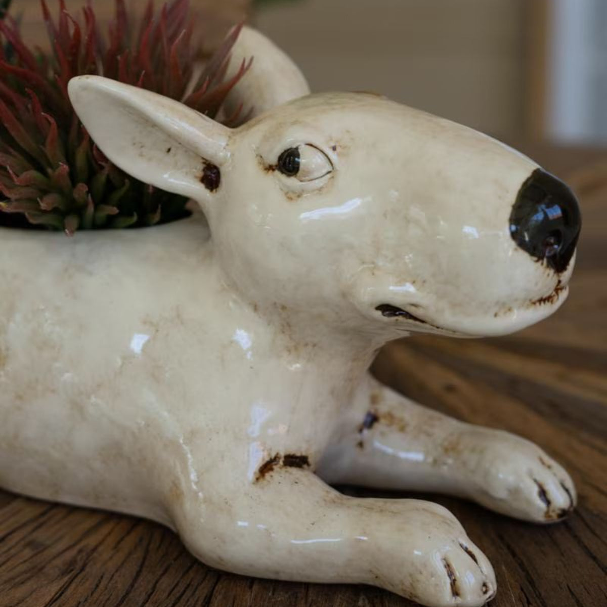 Side view of white ceramic dog planter