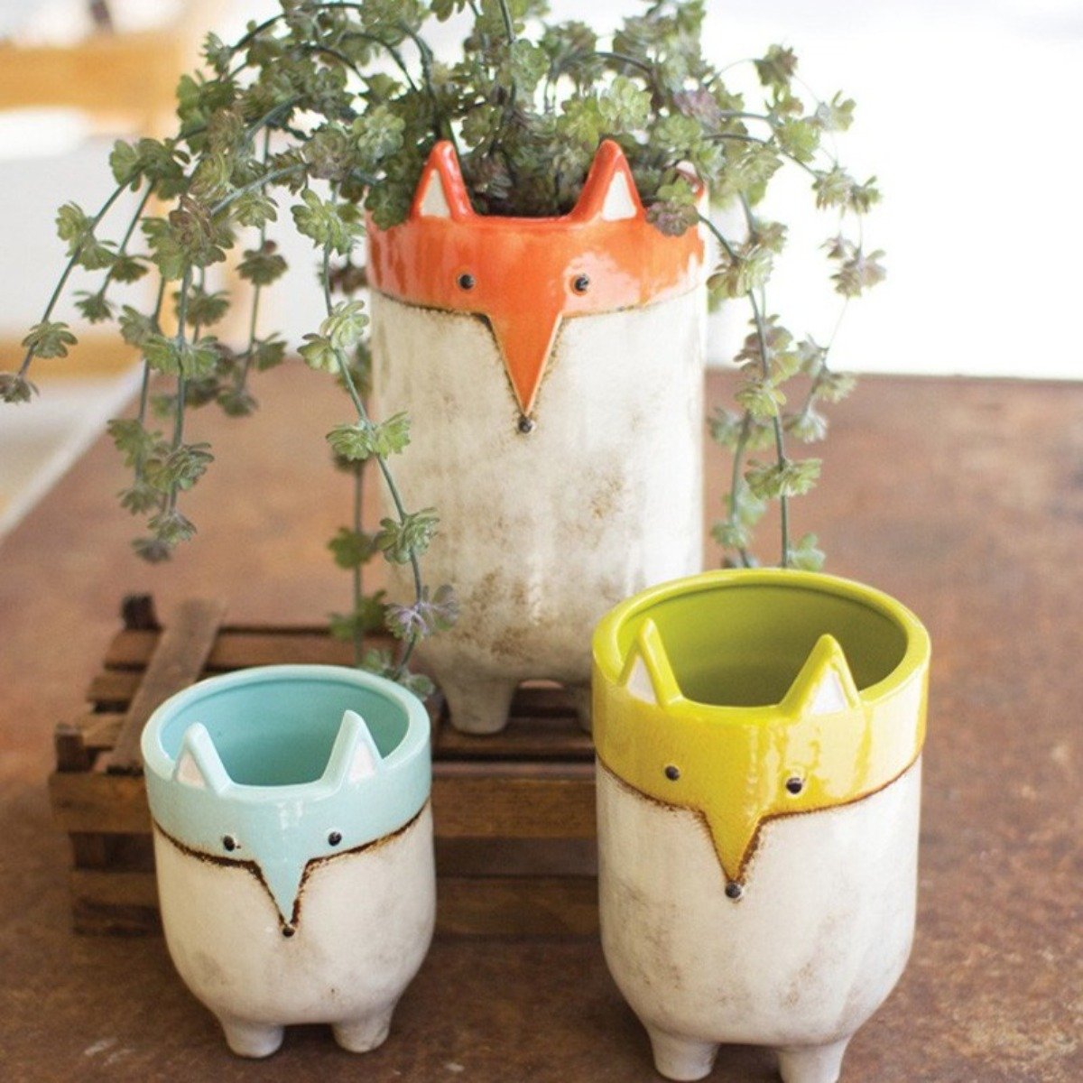 Three glazed ceramic fox planters in graduated sizes