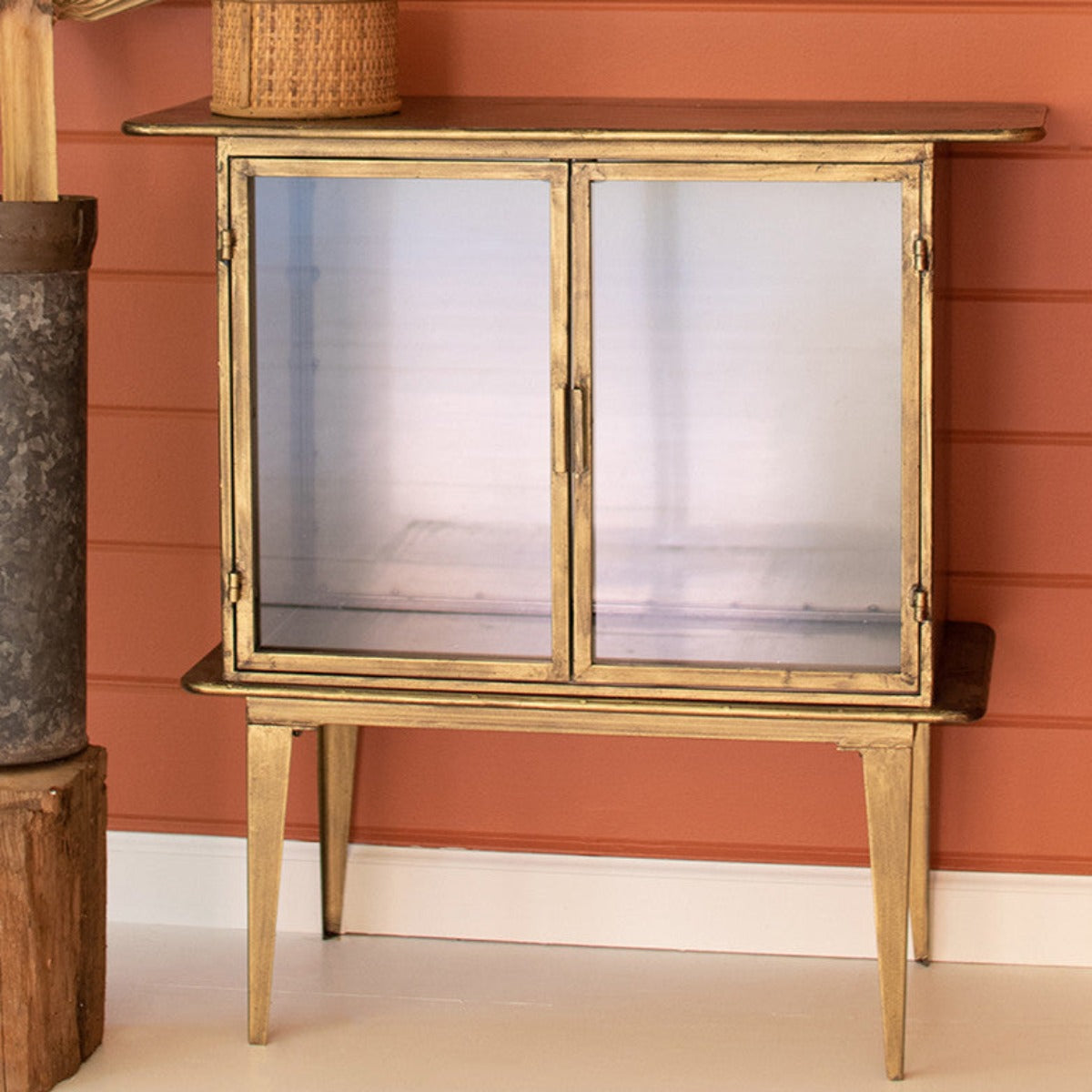 Front view of brass glass door accent cabinet