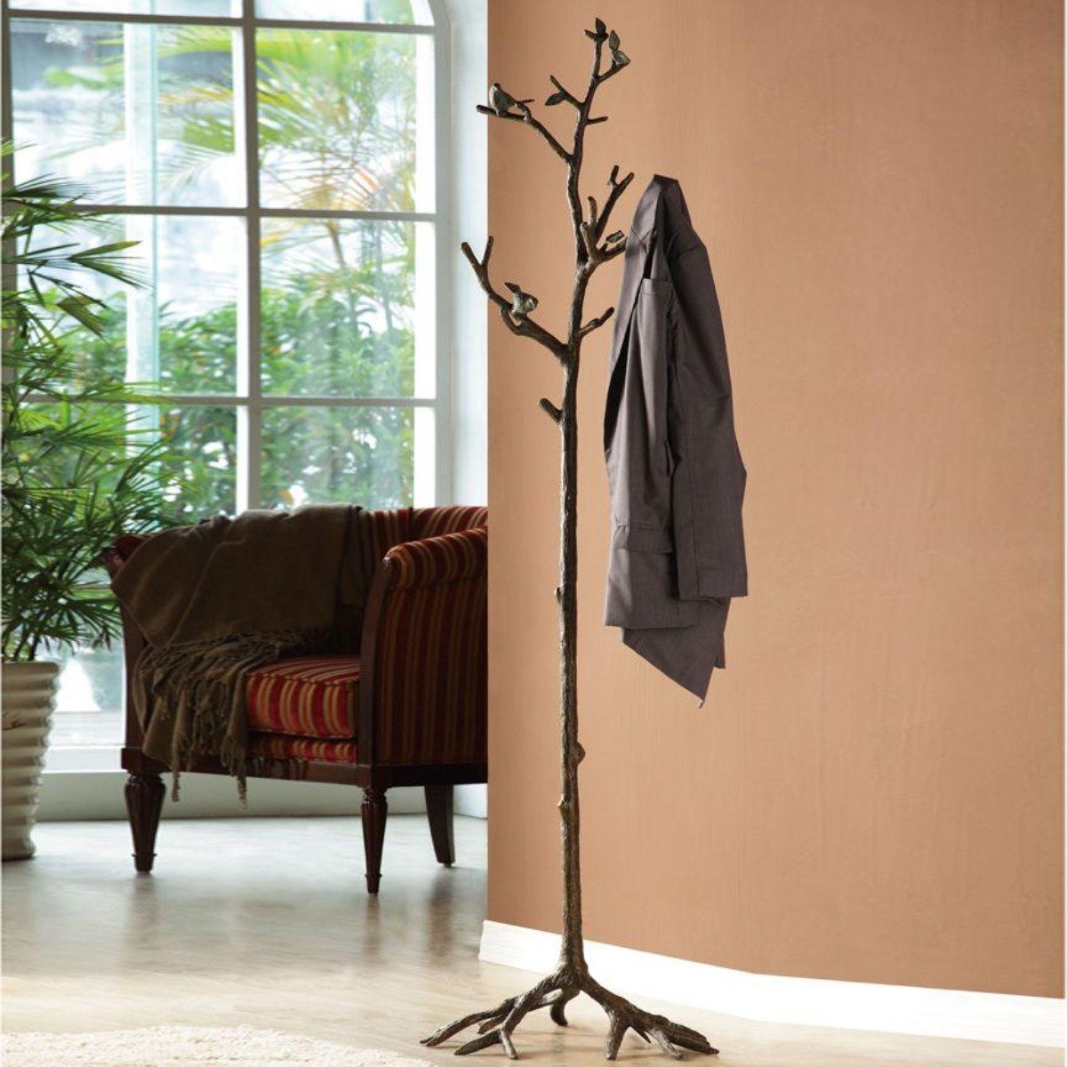 Decorative metal coat rack with branching form and bird accents